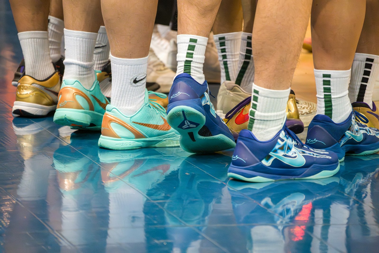 Basketball players' feet in colourful sneakers on a court