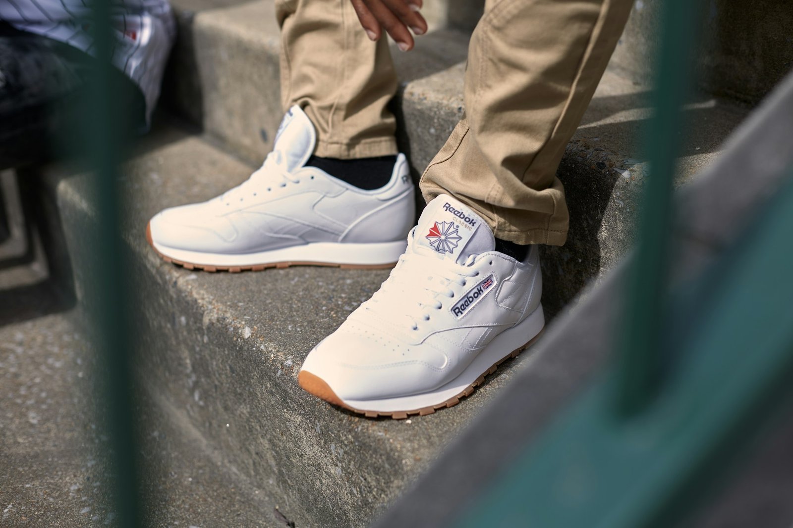 Person wearing white canvas high-top sneakers