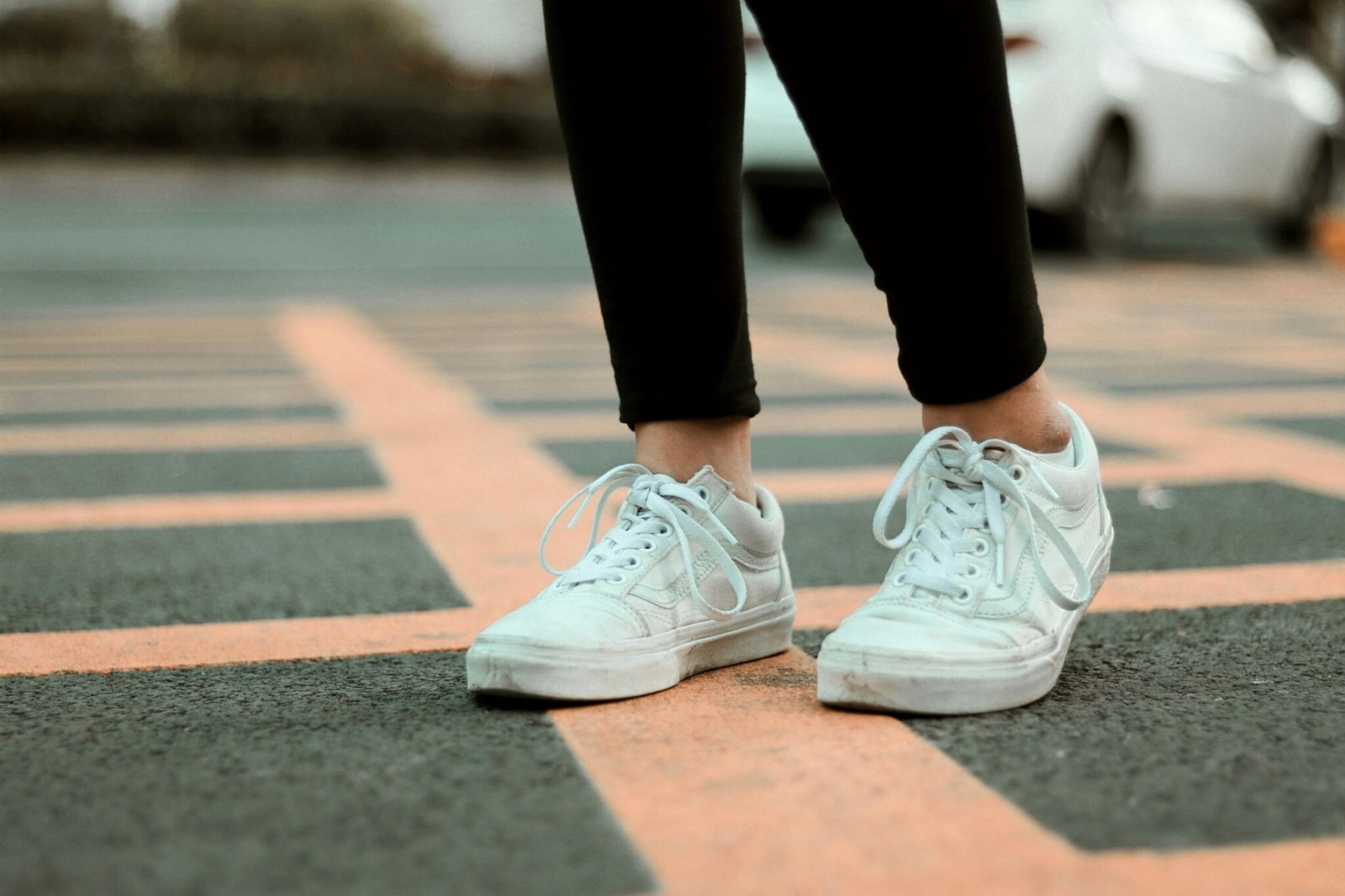 Person in black pants and white sneakers