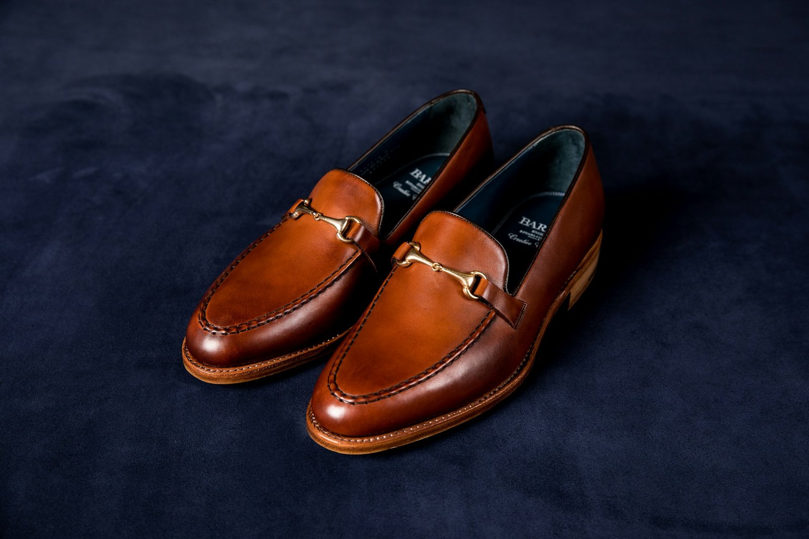 Brown leather loafers on blue fabric