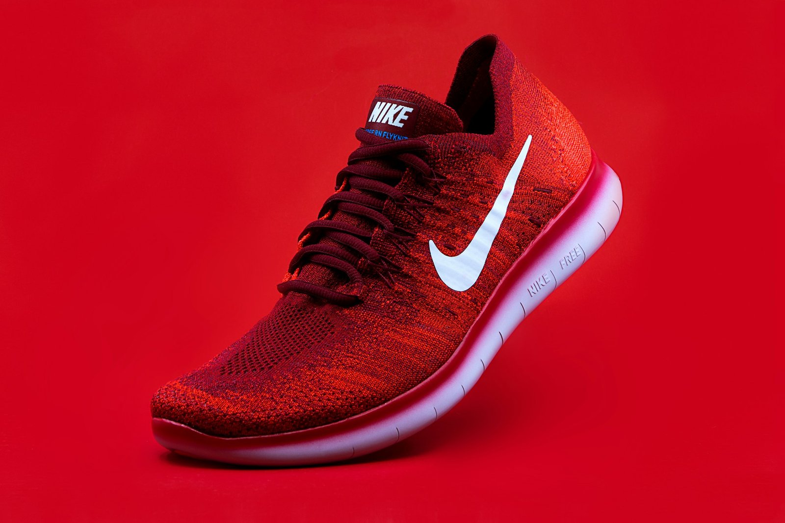 Red Nike sneaker on a red background