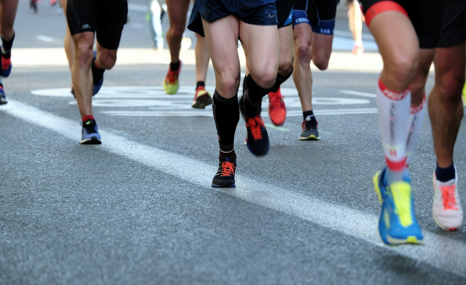 People running on an asphalt road