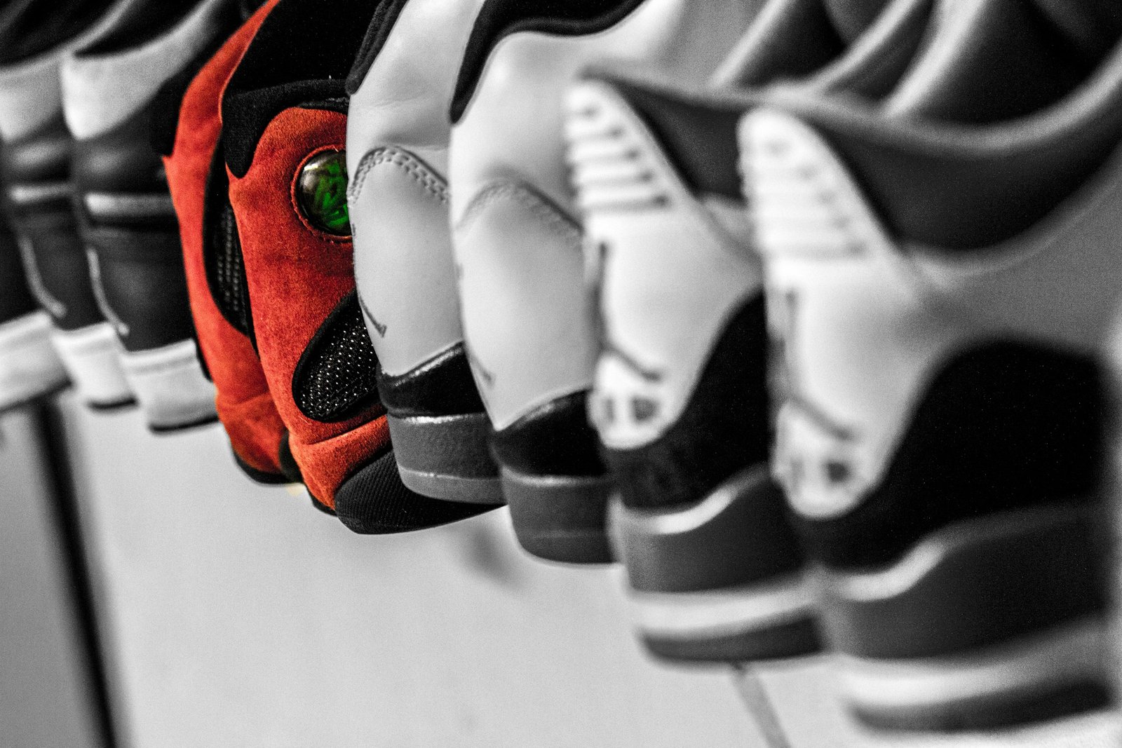 Many pairs of colourful sneakers lined up